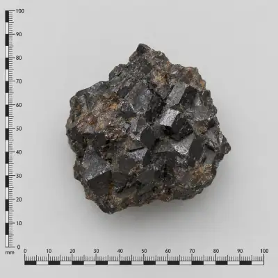 Customer specimen 14: black crystalline chunk, photographed beside a millimeter scale